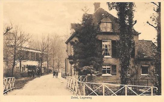 Het Slot en omgeving0014, Lageweg hoek Karpervijver. 1941.jpg - Lageweg. Op de achtergrond is de achterzijde van de Kosmos te zien die aan de Driebergseweg ligt. Rechts Lageweg 2 (nu 9). Gebouwd in 1800. De Smederij en Slotenmakerij van Fries. De Smid P.F. Fries maakt vooral siersmeedwerk voor hekken en poorten van buitenplaatsen en dergelijke, maar ook sloten. Later kwam daar de fietsenreparatie bij. Zo’n 75 jaar geleden, na het verdwijnen van de smederij, bevond zich op deze plek het kleuterschooltje van Mejuffrouw W.E. Fries. Hierna was het pand jarenlang bekend als schoenmakerij van H.H. van Lunteren. Sindsdien staat het leeg. Opname van 1927.